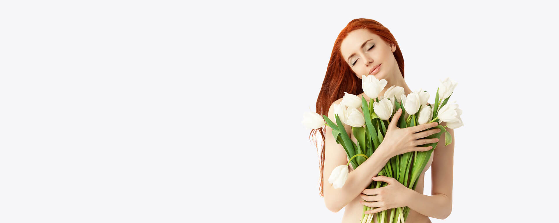 Beautiful nude girl holding white tulip